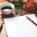 blank-paper-with-pen-and-coffee-cup-on-wood-table